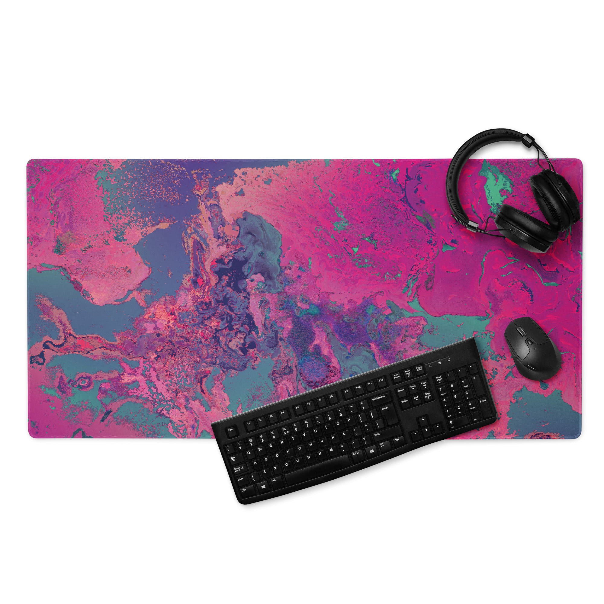 Desk setup with a colorful abstract mouse pad, keyboard, mouse, and headphones on a white background.