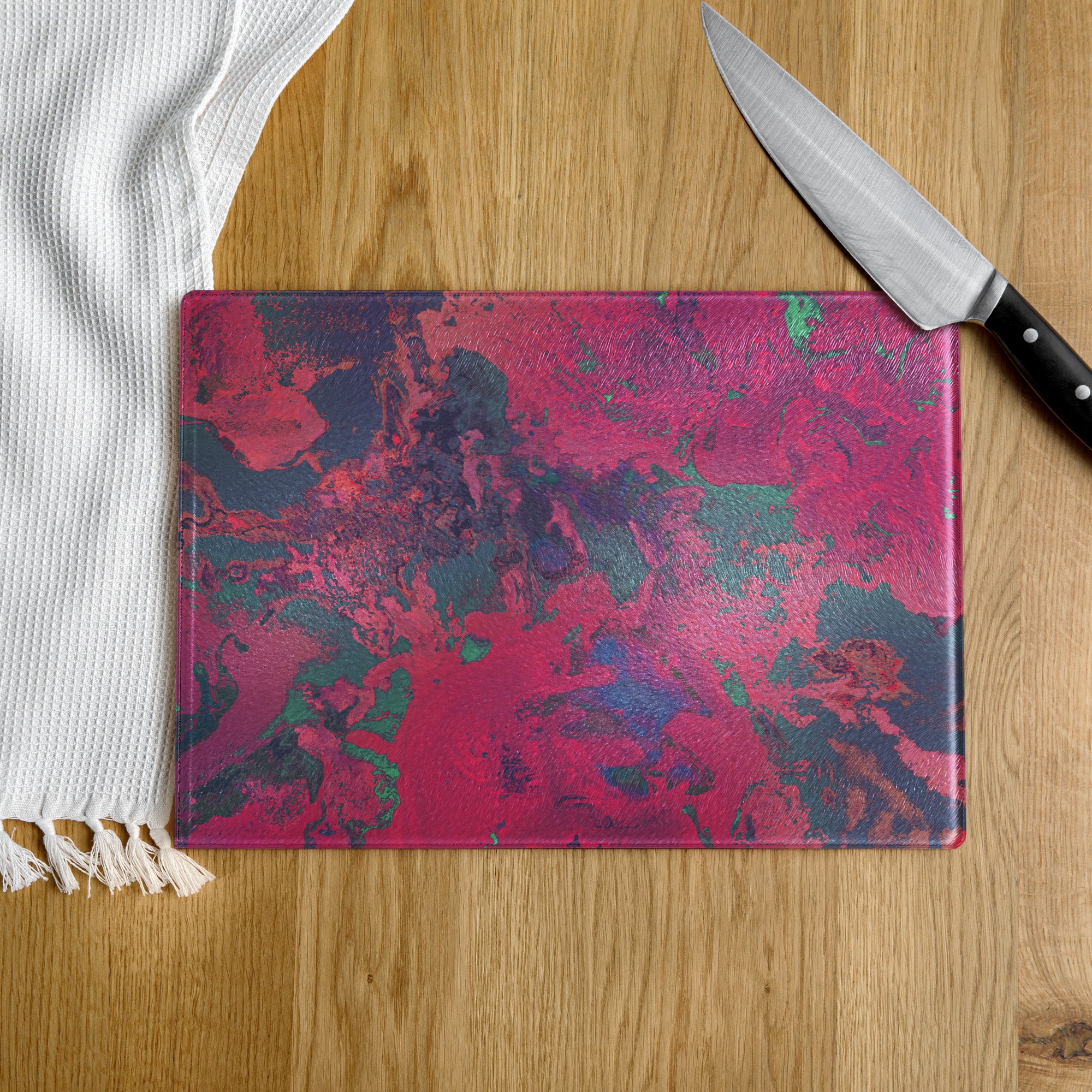 Colorful cutting board with a knife on a wooden surface