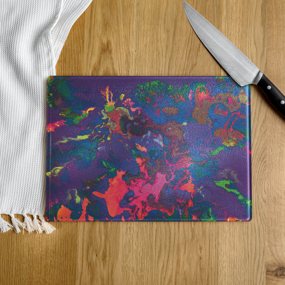 Colorful abstract-patterned glass cutting board with a knife on a wooden surface