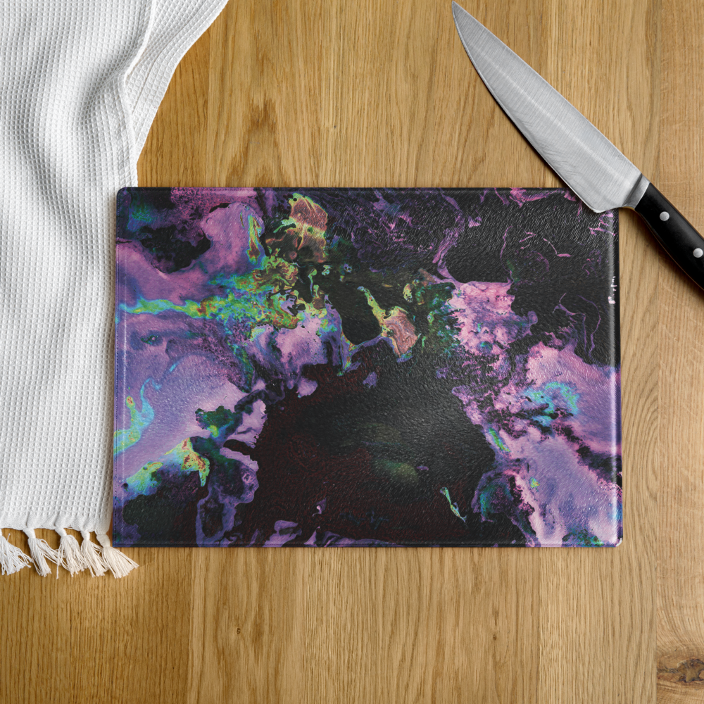 Colorful lavender abstract-patterned glass cutting board with a knife on a wooden surface