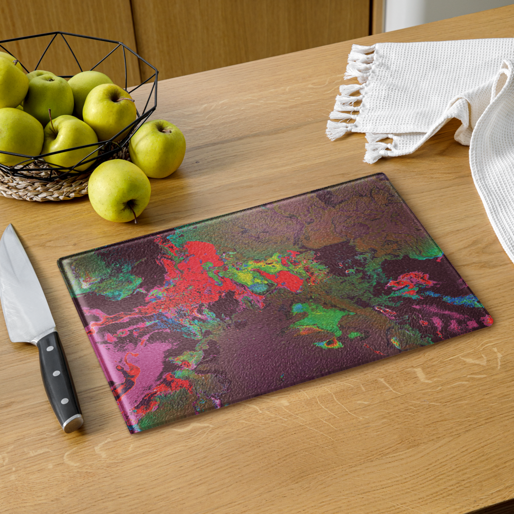 Colorful marbled cutting board on a wooden table with apples and a knife.