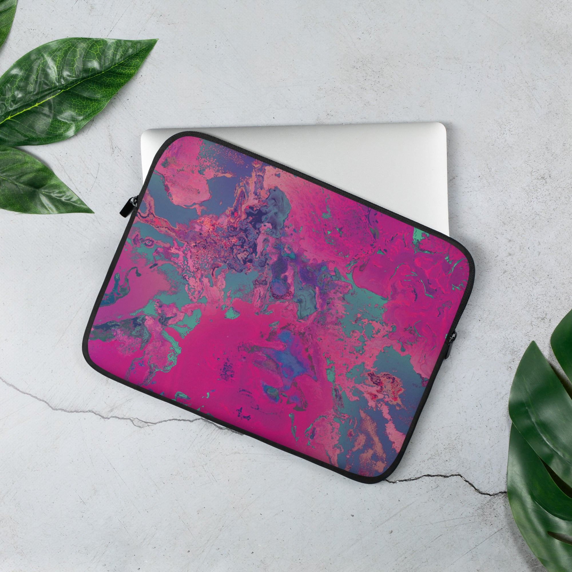 Laptop sleeve with a magenta and blue abstract pattern on a white background