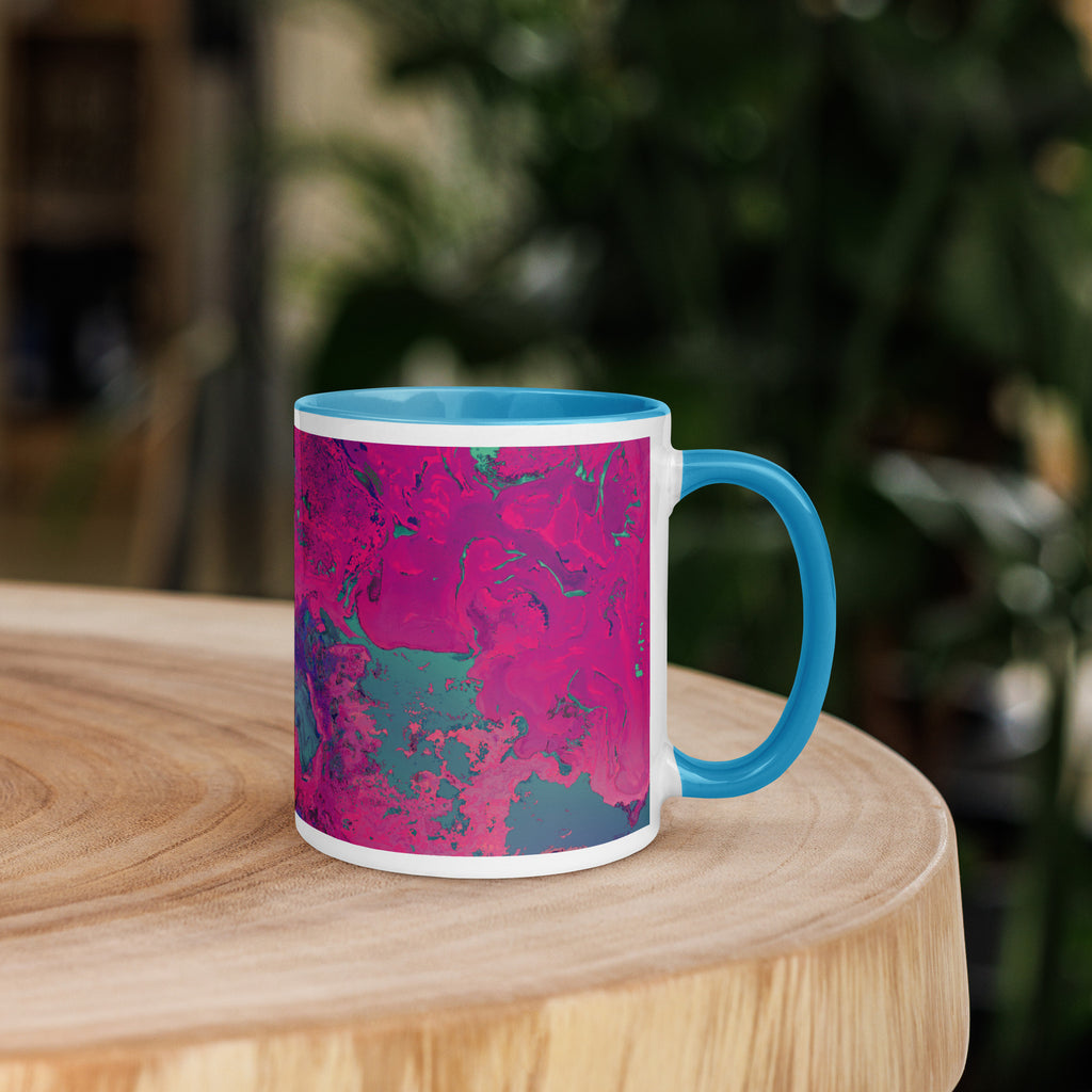 Mug with pink and blue abstract pattern on a wooden surface