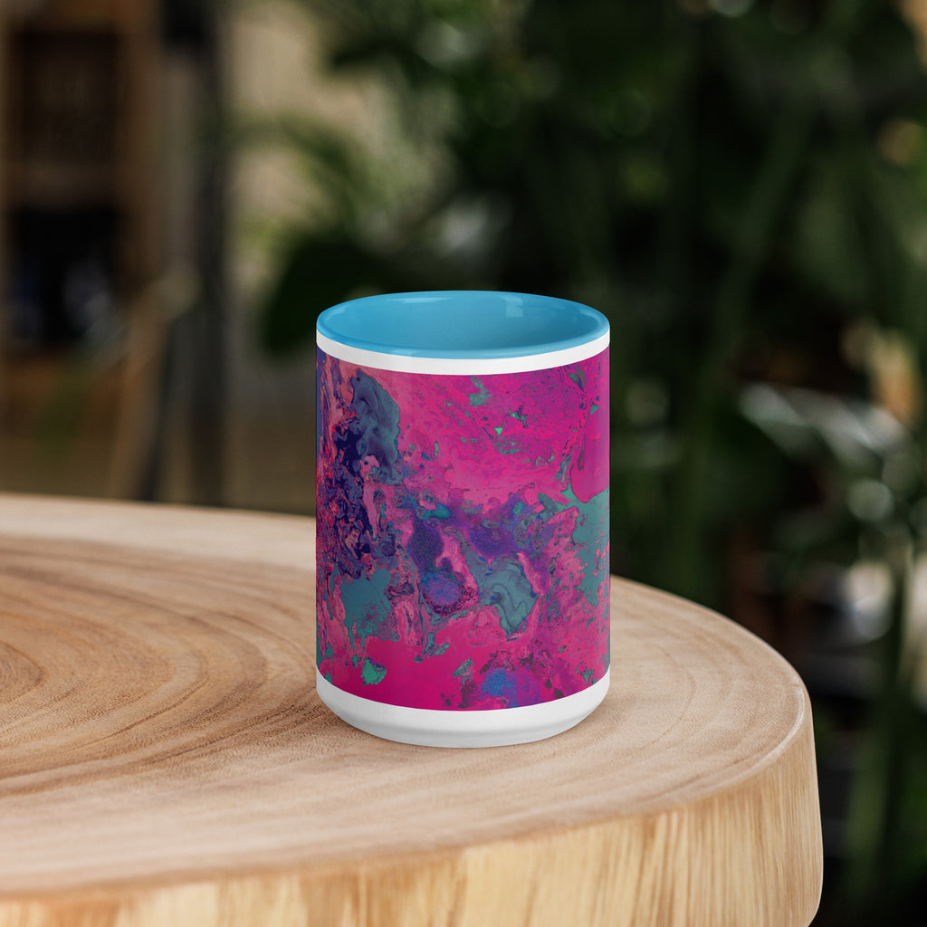 Colorful mug with blue interior on a wooden surface