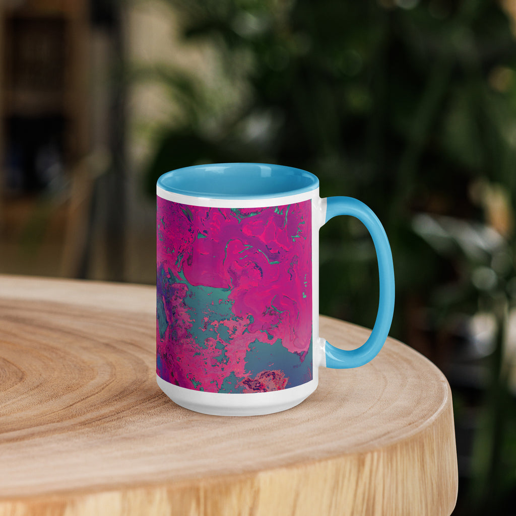 Mug with pink and blue abstract design on a wooden surface