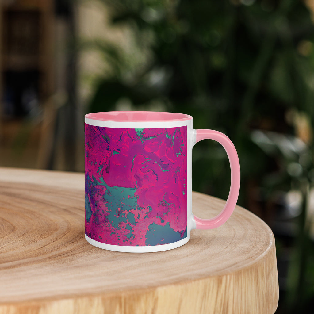 Mug with pink and blue abstract pattern on a wooden surface